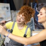 close up women painting canvas