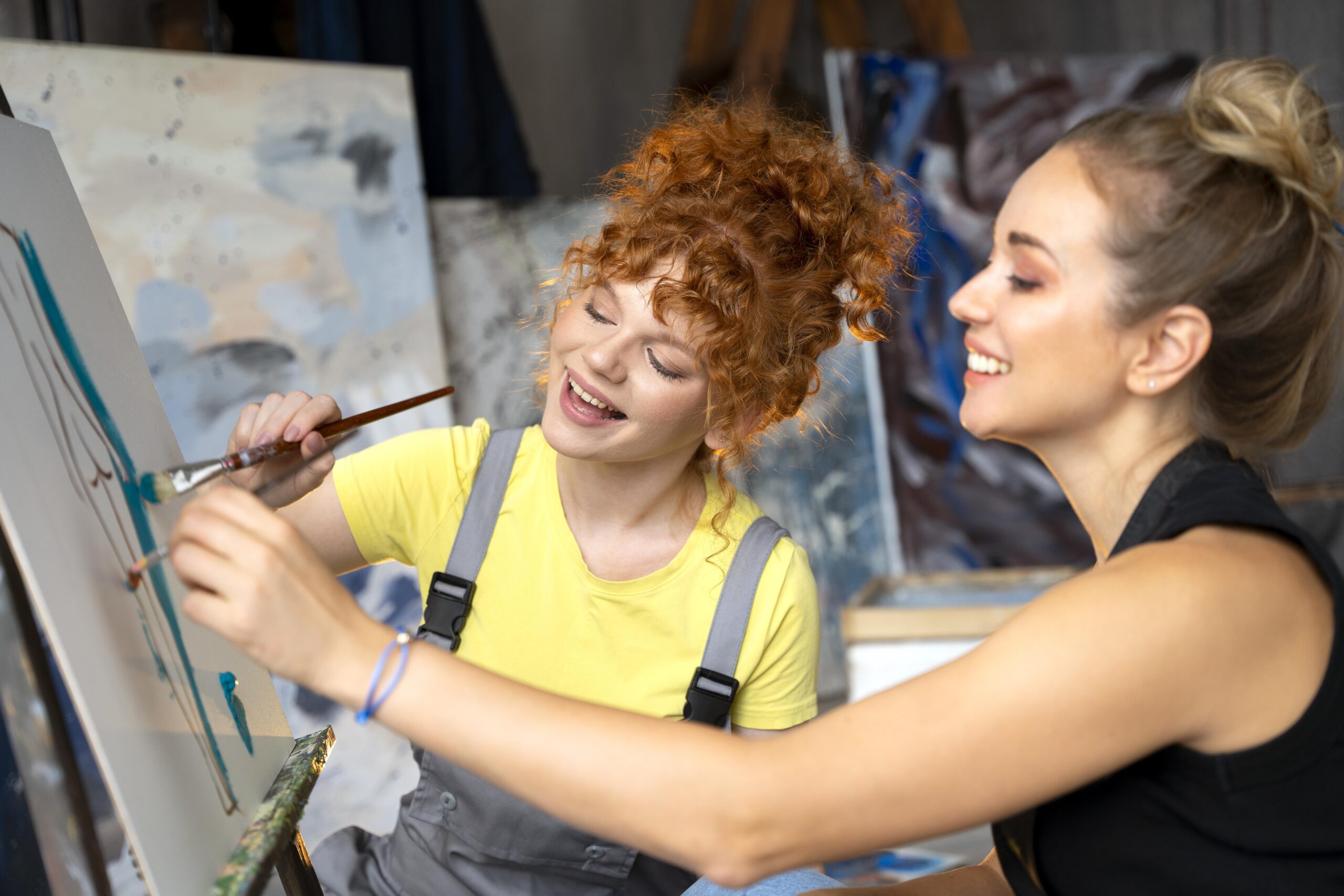 close up women painting canvas