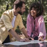 couple outdoors consulting map
