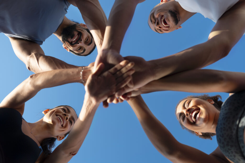 Programs Group People Putting Their Hands Together While Exercising Outdoors 1024x683